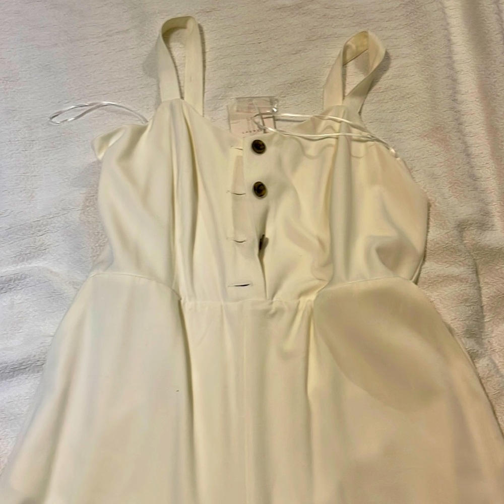 Cream jumpsuit with marbled buttons
